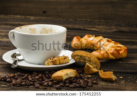 drunk cappuccino and cakes on dark background