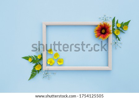 Spring, floral background. Flower composition. Frame with yellow-orange flowers on a light background. The concept of spring. Mother's Day, Women's Day. Flat lay, space for text. View from above.