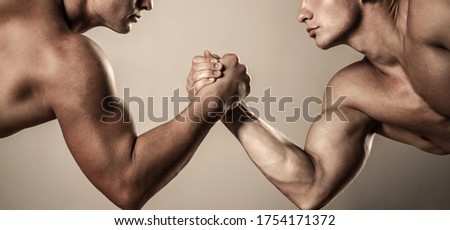 Two hands. Muscular men measuring forces, arms. Hand wrestling, compete. Hands or arms of man. Muscular hand. Clasped arm wrestling.