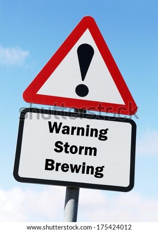 A red and white warning roadsign with a Storm Brewing ahead concept. against a partly cloudy sky background