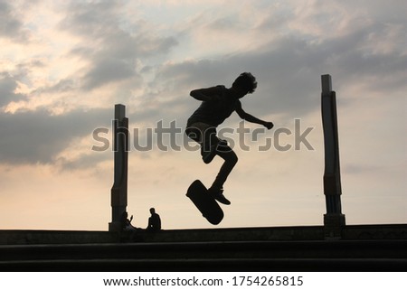 a boy with skate boarding silhoutte 