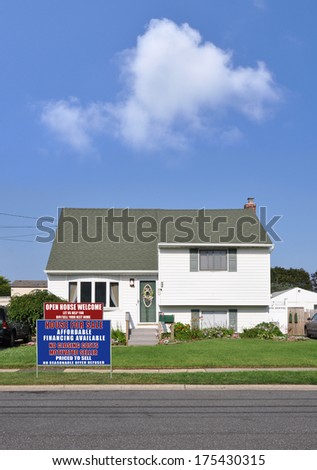 Real Estate Sign for sale welcome open house front yard lawn of suburban home residential neighborhood USA blue sky clouds