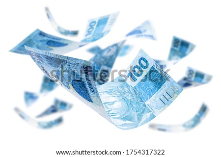 One hundred Brazilian banknotes falling on isolated white background, with spot focus. Grand prize, lottery or wealth concept.