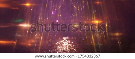 background of abstract glitter lights. gold and purple. de focused