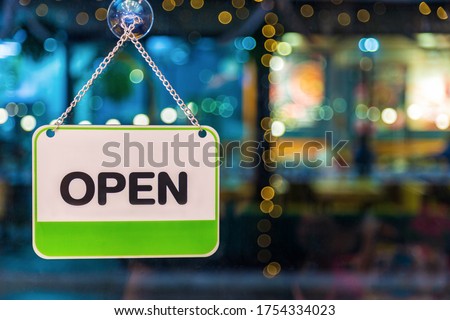 A white and green open sign hanging on glass coffee shop door at night, Food drink and business service concept