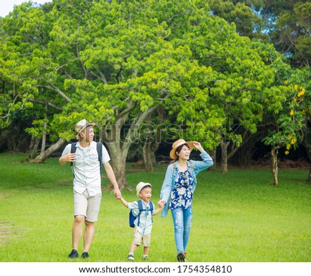 happy family hiking through the forest