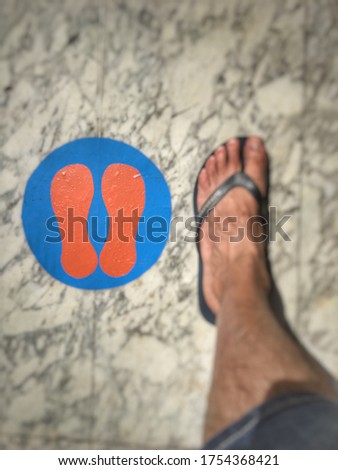 sign on the floor to respect social distance before entering at the beach, italy 2020 