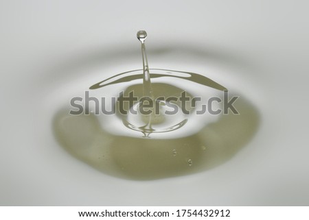 Dripping colorless oil on white background. Royalty-Free Stock Photo #1754432912