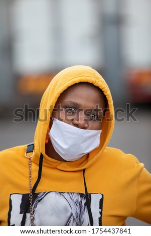 African girl with a yellow hoodie jacket in the streets of Gaborone, Botswana