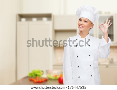 cooking, gesture and food concept - smiling female chef showing ok hand sign