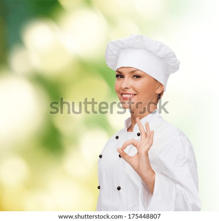 cooking, gesture and food concept - smiling female chef showing ok hand sign