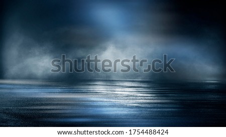 Dark dramatic abstract scene background. Neon glow reflected on the pavement. Smoke, smog and fog. Dark street, wet asphalt, reflections of rays in the water. Abstract dark blue background.  Royalty-Free Stock Photo #1754488424