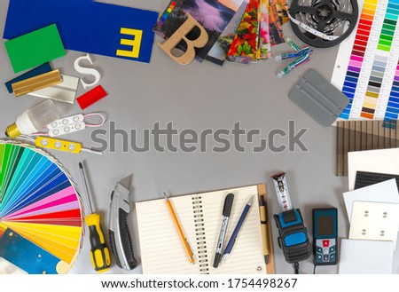 Outdoor advertising background. Palette of film colours, aluminium profile and plastic samples and instruments on the silver background.