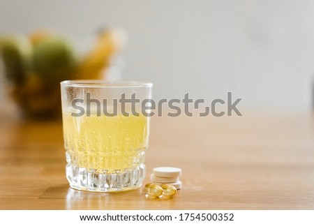 Close up glass with water and sparkling pill. Magnesium anti-stress, painkiller or orange drink