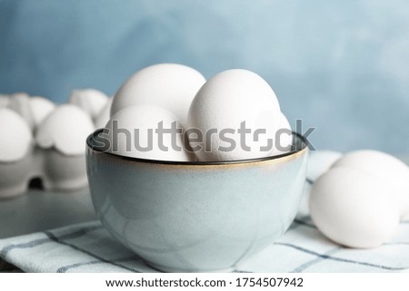 Chicken eggs in ceramic bowl on table