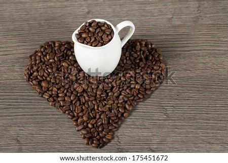 Coffee beans on wooden tale hart shape