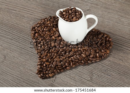 Coffee beans on wooden tale hart shape