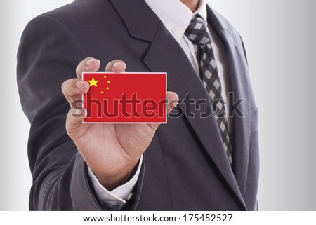 Businessman in suit holding a business card with China Flag 