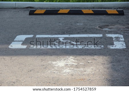 Disabled Parking space marked with a white sign