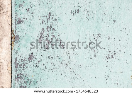 background and texture of old concrete wall with cracked paint on it.