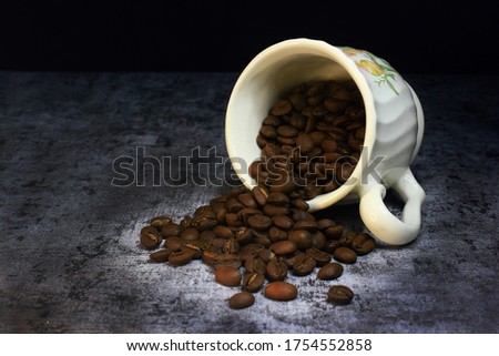 photo of coffee beans that are ready to be ground in a cup, illustrating the freshness of the coffee to be processed, coffee is a popular caffeine supplement consumed by many people