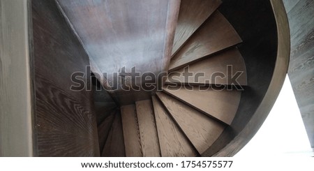 Dark brown wooden staircase with original pattern