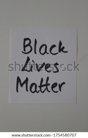 Handwritten sign saying 'black lives matter' in black ink on a white background. Studio shot