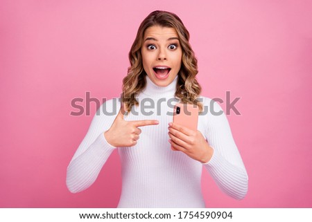 Close-up portrait of her she nice-looking attractive lovely gorgeous charming amazed cheerful cheery crazy wavy-haired girl demonstrating device isolated on pink pastel color background