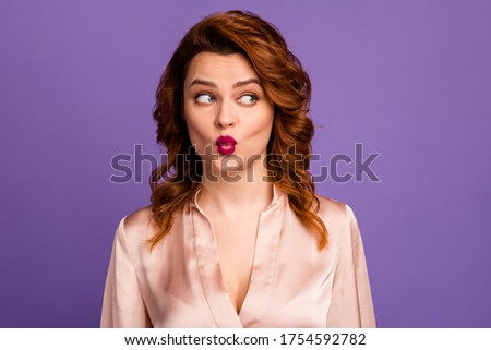 Closeup photo of charming pretty lady red bright pomade send air kisses handsome guy look side empty space shy wear beige shirt blouse isolated purple color background
