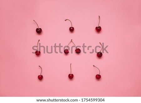 A pile of ripe cherries. Ripe cherries background. Close up of wild cherries on the pink background.