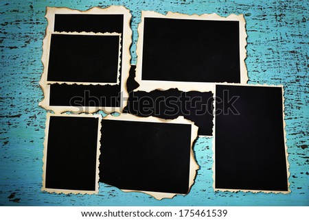 Blank old photos on color wooden background