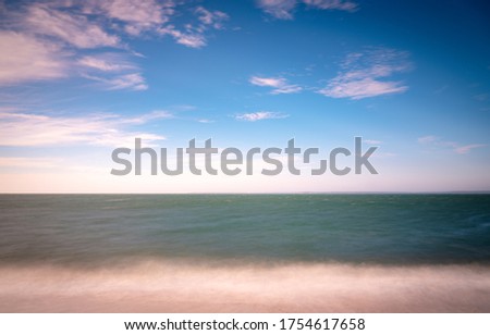 Tranquil soft seascape over the turquoise color sea on Cape Cod. 