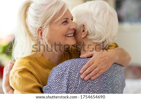 Woman hugging her elderly mother

