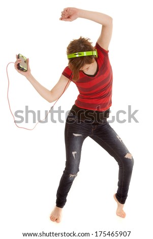a woman dancing around to her music she is listening to .
