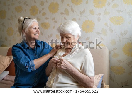 Woman helping senior woman dress in her bedroom
 Royalty-Free Stock Photo #1754665622