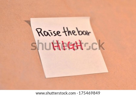 Text raise the bar high on the short note texture background