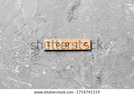 topic word written on wood block. topic text on cement table for your desing, concept.