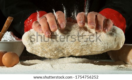 Freeze motion of cooker processing yeast dough. Food preparation concept, ingredients around