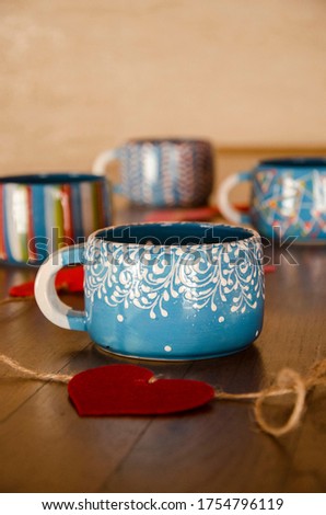 Still life with colorful cups and hearts. Valentine theme cute photo. Cozy home details.