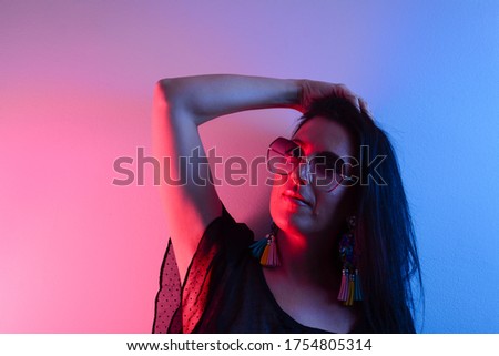 Fashion girl wear stylish pink glasses looking at camera isolated on party purple studio background, horizontal banner for website design, portrait, copy space