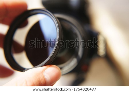 Hand Holding DSLR Camera Lens Filter Royalty-Free Stock Photo #1754820497