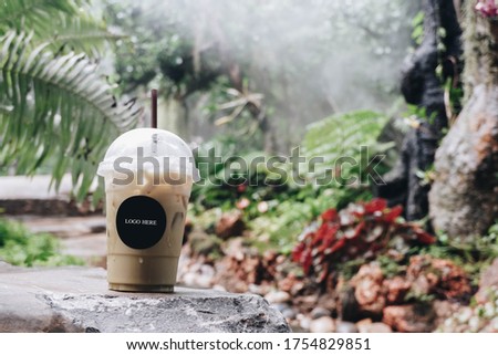 Ice Coffee on stone with garden blackground