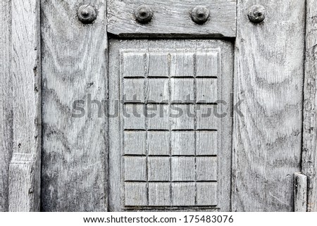 Close-up image of a hardwood gray door, showing texture.