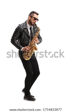 Full length shot of a man in a leather jacket playing a saxophone isolated on white background Royalty-Free Stock Photo #1754833877