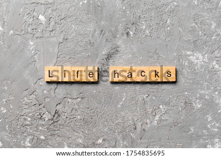 life hacks word written on wood block. life hacks text on table, concept.