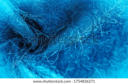 Background texture, decorative ornament, blue silk fabric, woven threads on the fabric, fluffy effect, sensation, appearance or surface texture
