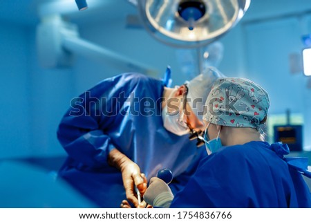 Doctor performs minimally-invasive surgeon using a robotic device. Minimal invasive surgical innovation, medical robot surgery with endoscopy. Royalty-Free Stock Photo #1754836766