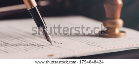 Law, notary background theme. Fountain pen and handmade paper on desk Royalty-Free Stock Photo #1754848424