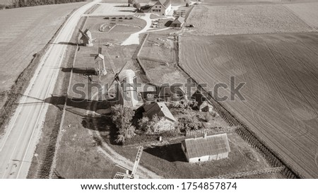 Beautiful panoramic aerial view photo from flying drone to summer fields and Angla windmills in Leisi Parish. Saarema Island, Estonia. Black and white picture