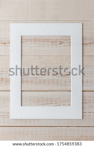 empty white frame in the middle of a wooden textured background. template for advertising with copy space